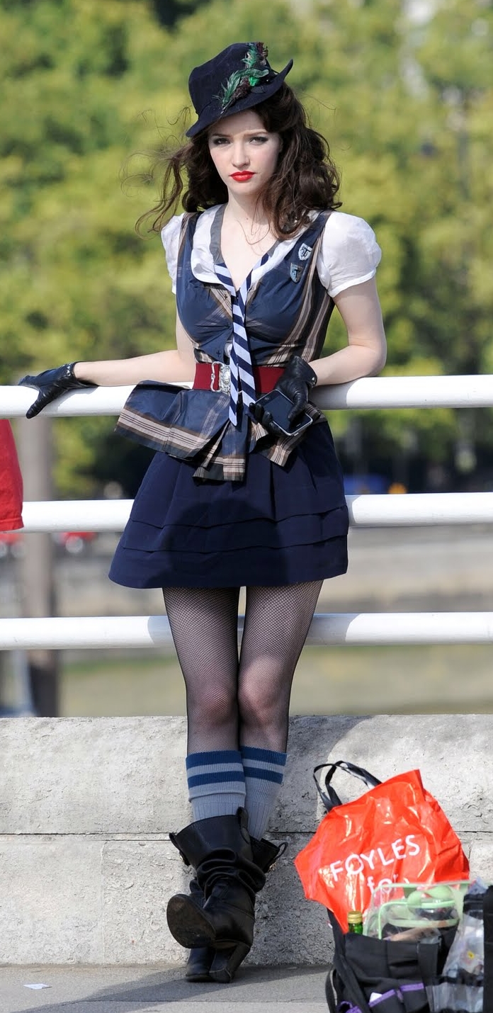 Brunette Schoolgirl wearing Black Fishnet Pantyhose and Black Boots